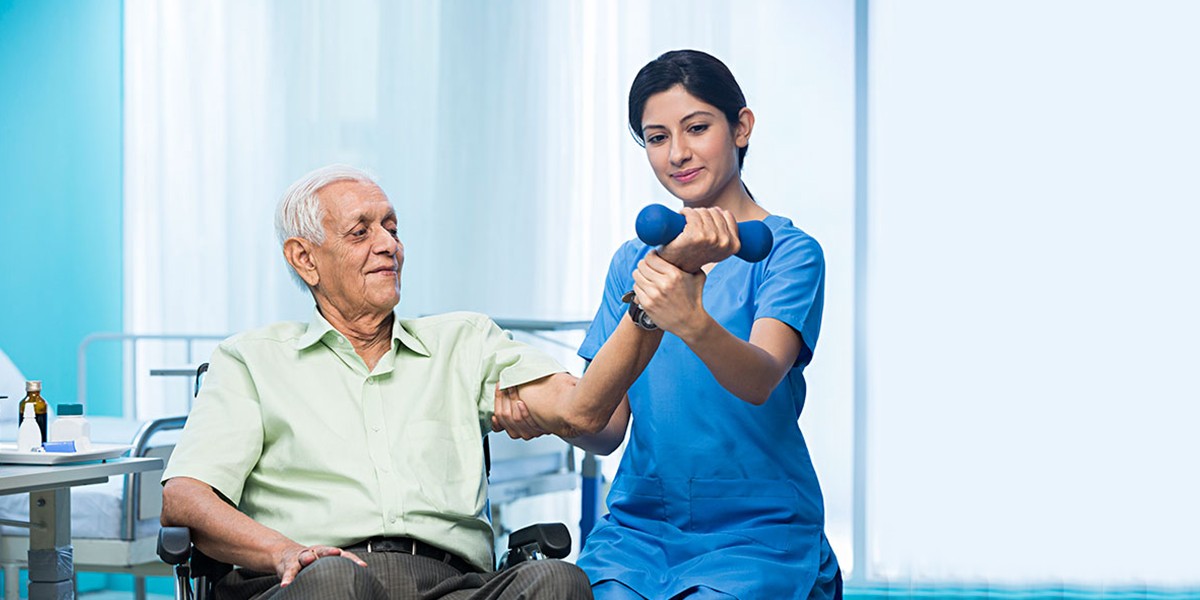 Aged Man Getting Physiotherapy from Nurse at Atman Care Home